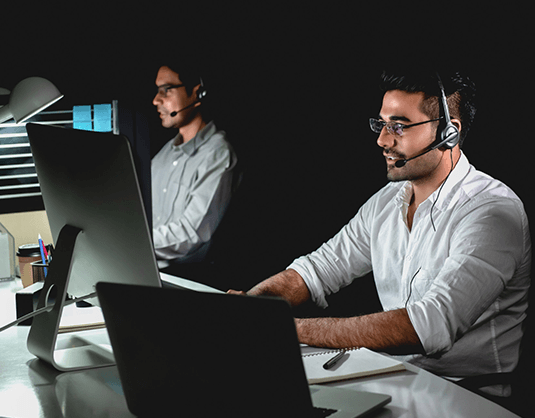 Two Men Working On Desktop